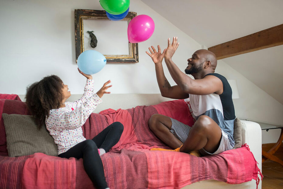 Father and daughter share joy and lightness while playing with balloons